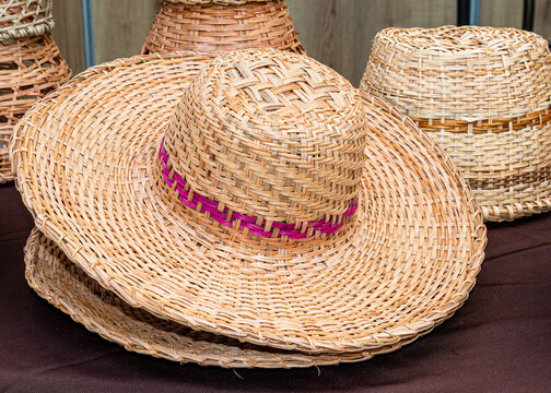 Title: Handmade sombrero (Panama Hat) made from natural plant fiber at the traditional outdoor market in Cuenca, Ecuador.