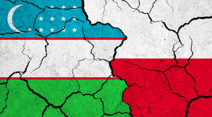 Flags of Uzbekistan and Poland on cracked surface - politics, relationship concept