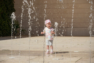 small kid girl near fountain in Lisboa Portugal. High quality photo