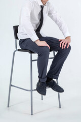 Young male sitting on a bar chair