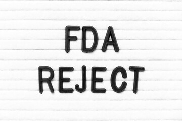 Black color letter in word FDA reject on white felt board background