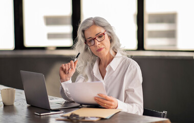 Manager Woman Reading Candidate CV, Holding Paper In Modern Office