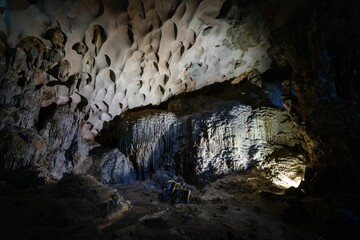 a light shines through the entrance to an underground cave