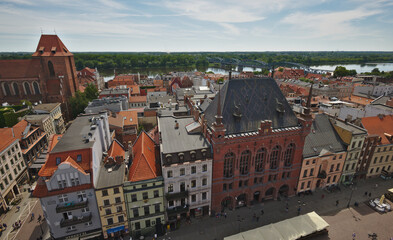 Fototapeta na wymiar Aerial view on old view of the old town of Torun with the Vistula river in the background from the top of Town Hall tower . Torun, Poland.