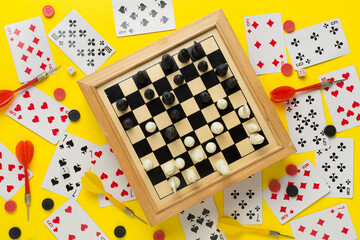 Different board games on color background, top view