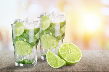 Tasty cold cocktail with ice and fresh lime slice