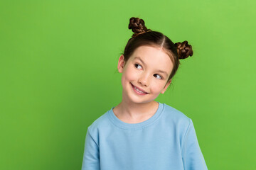 Portrait of funny small girl have two hair buns looking empty space interesting wondering isolated...
