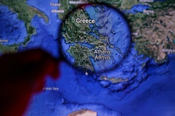 Greece trough magnifying glass on map