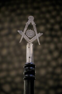 Open masonic compass is displayed on top of a wine bottle: freemason concept
