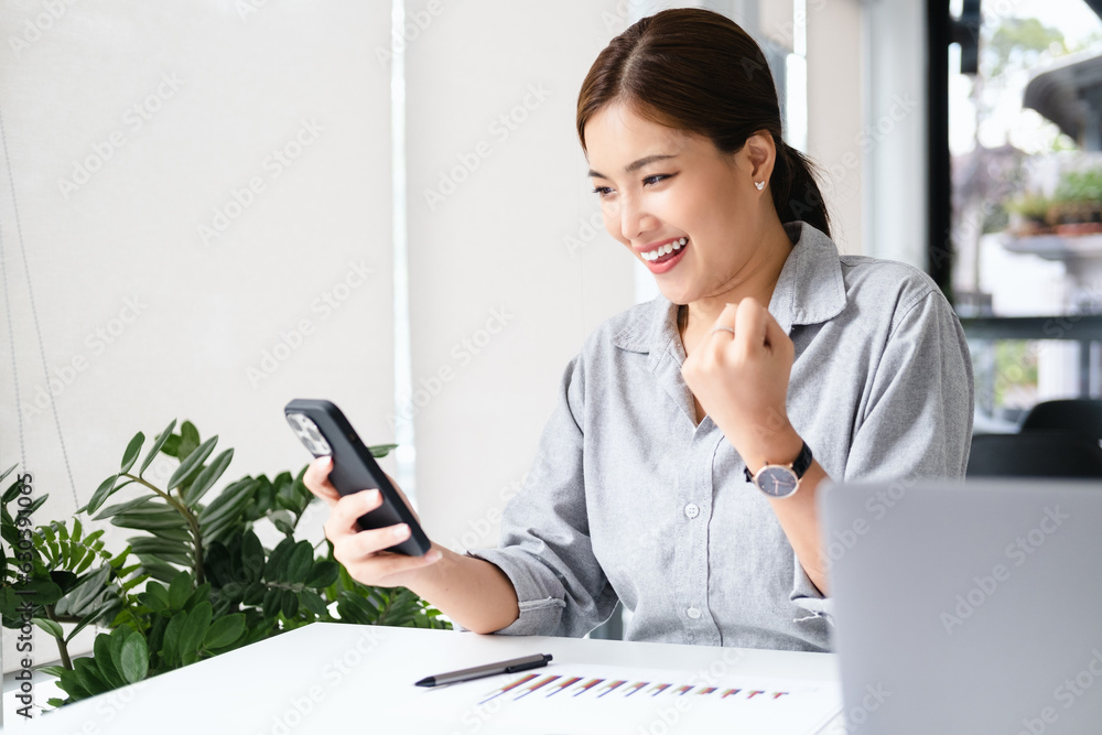 Wall mural smiling beautiful business asian woman working on office desk computer. small business sme people em