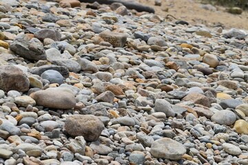 Array of stones and pebbles in a tranquil beach setting