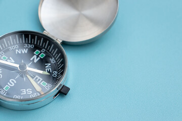 A compass isolated on blue background, after some edits.