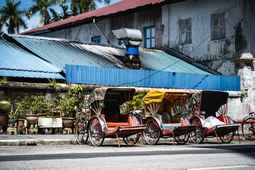 Fototapeta na wymiar Array of vintage Tuk Tuks parked in a row in Georgetown, Penang, Malaysia