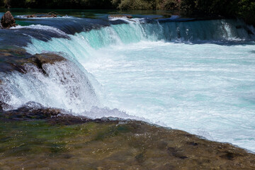 Manavgat waterfall Manavgat River is near the city of Side, 3 km north of Manavgat in Turkey. A wide stream of water falls from a low height.