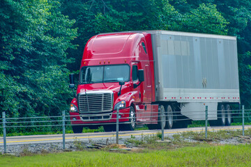 Red Eighteen-Wheeler On Stretch Of Rural Interstate