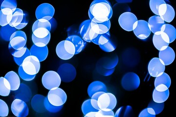 Closeup of blue bokeh circles on a dark background