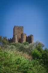 Fototapeta na wymiar Beautiful shot of the majestic Alm Castle under a bright blue sky in Portugal