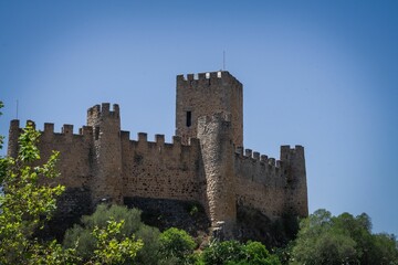 Fototapeta na wymiar Beautiful shot of the majestic Alm Castle under a bright blue sky in Portugal