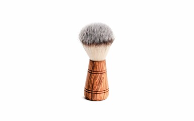 Wooden shave brush against a solid white background