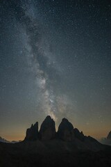 Star-filled sky view with the Dolomites mountains silhouetted against it