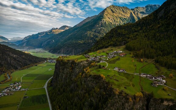 Aerial view of a green valley featuring a charming village in the mountains of Langenfeld,Austria