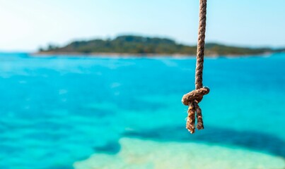 Closeup view of a rope on background of water