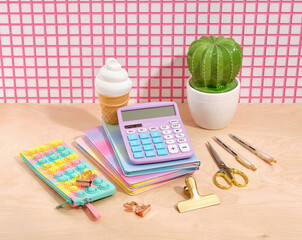 Office supplies set. Calculator, scissors, notebooks, pencil case pop it, figurine of a cactus in a white pot.