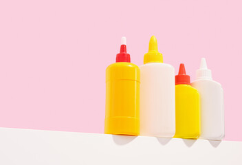 Various tubes of office glue stand on the table. Copy space for text.