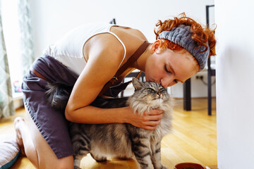 Favorite pet Maine Coon cat and his mistress at home