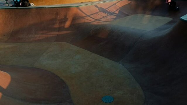 Skater rides in the park in the sunshine