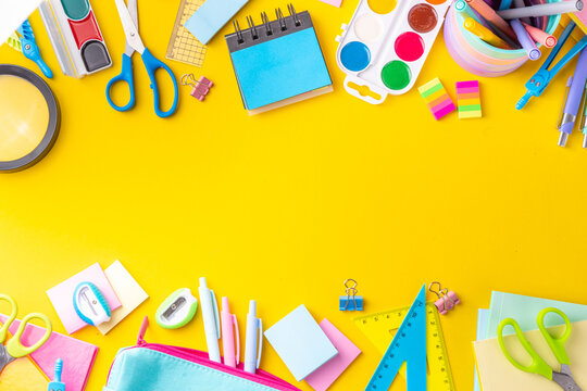 School equipment high-colored bright yellow flat lay. Various school education and office supplies, accessories. Back to school sale background top view copy space
