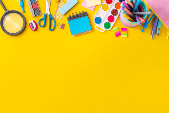 School equipment high-colored bright yellow flat lay. Various school education and office supplies, accessories. Back to school sale background top view copy space