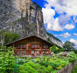 Switzerland travel . most scenic places. beautiful Lauterbrunnen village with traditional wooden houses and valley surrounded by impressive Alps mountains and waterfalls © Freesurf