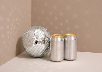 A party at a club. Alcoholic drinks in aluminum cans. Shining mirror disco ball.