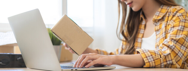 Online sell store, startup small business entrepreneur asian young woman using laptop computer...