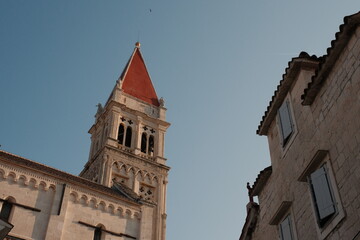 Fototapeta na wymiar Historic Trogir: Clocktower Amidst Facades