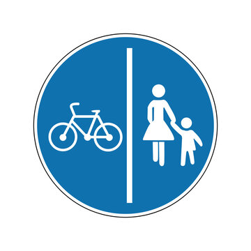 Pedestrian and bike path sign. Mandatory sign. Round blue sign. Separated path for cyclists and pedestrians. Road sign. Obey the rules of the road.