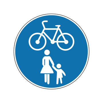 Path for cyclists and pedestrians. Walking and cycling sign. Required sign. Round blue sign. Road sign. Obey the rules of the road. Cyclist and cyclist.