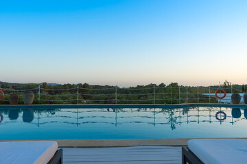 Swimming pool and blue sky on European summer holiday. Endless days of fun.