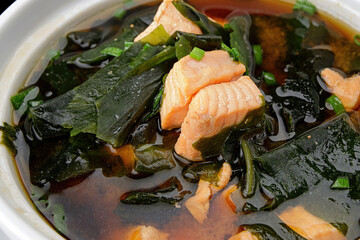 Miso soup with salmon, seaweed and onions
