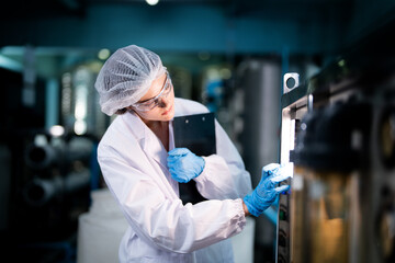 scientist worker checking the quality of Reverse osmosis machine system at the industrial factory....