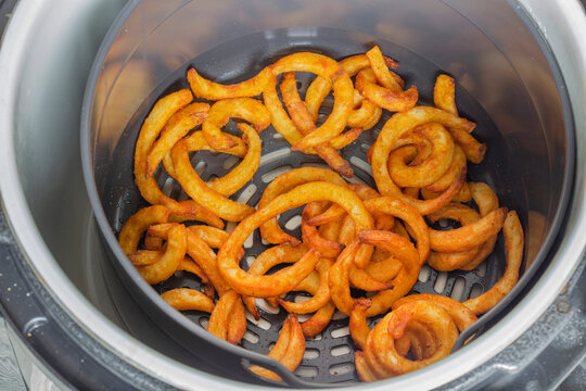 Curly fries cooked in an electric air fryer. Fast healthy alternative to a deep fat fryer