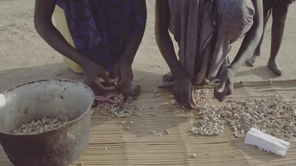 Mundari tribe women preparing peanuts Terekeka South Sudan