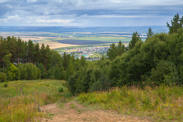 Rural Russian landscape with Belokurikha town on a background