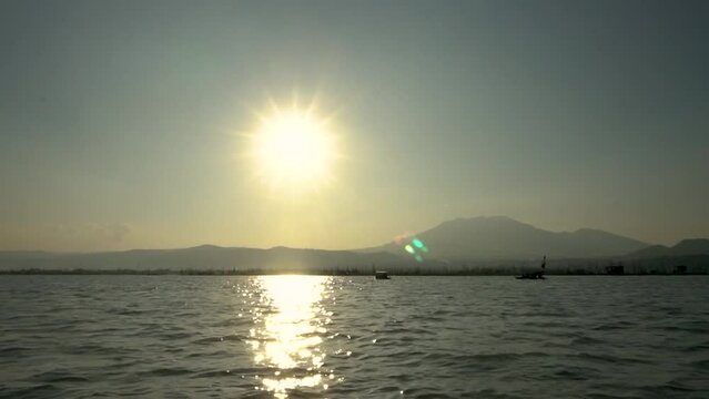 Ambarawa, Indonesia - July Tuesday 2023 : A boat heading towards the sunset at Rawa Pening.