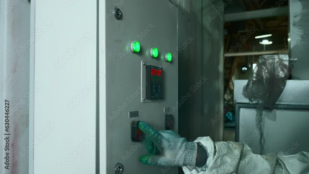 Poster worker in work uniform presses control panel of factory machines. creative. worker in mask and unifo