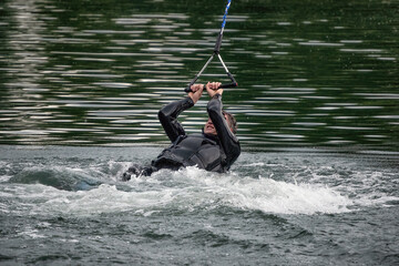 Wakeboarding on the sea on summer day in life jacket. Soft focus. Action blur.