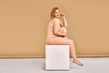 Body positivity, confidence and love for yourself and your body. Attractive adult blonde plus size...