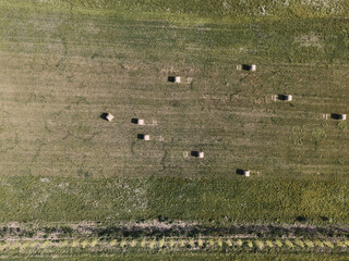 Fototapeta na wymiar Aerial shot of the Veneto fields, in Italy. Hay bales and plowed land.