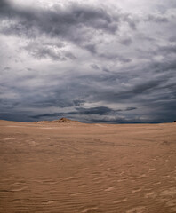 Fototapeta na wymiar Beautiful scenery of moving sand dunes after thunderstorm
